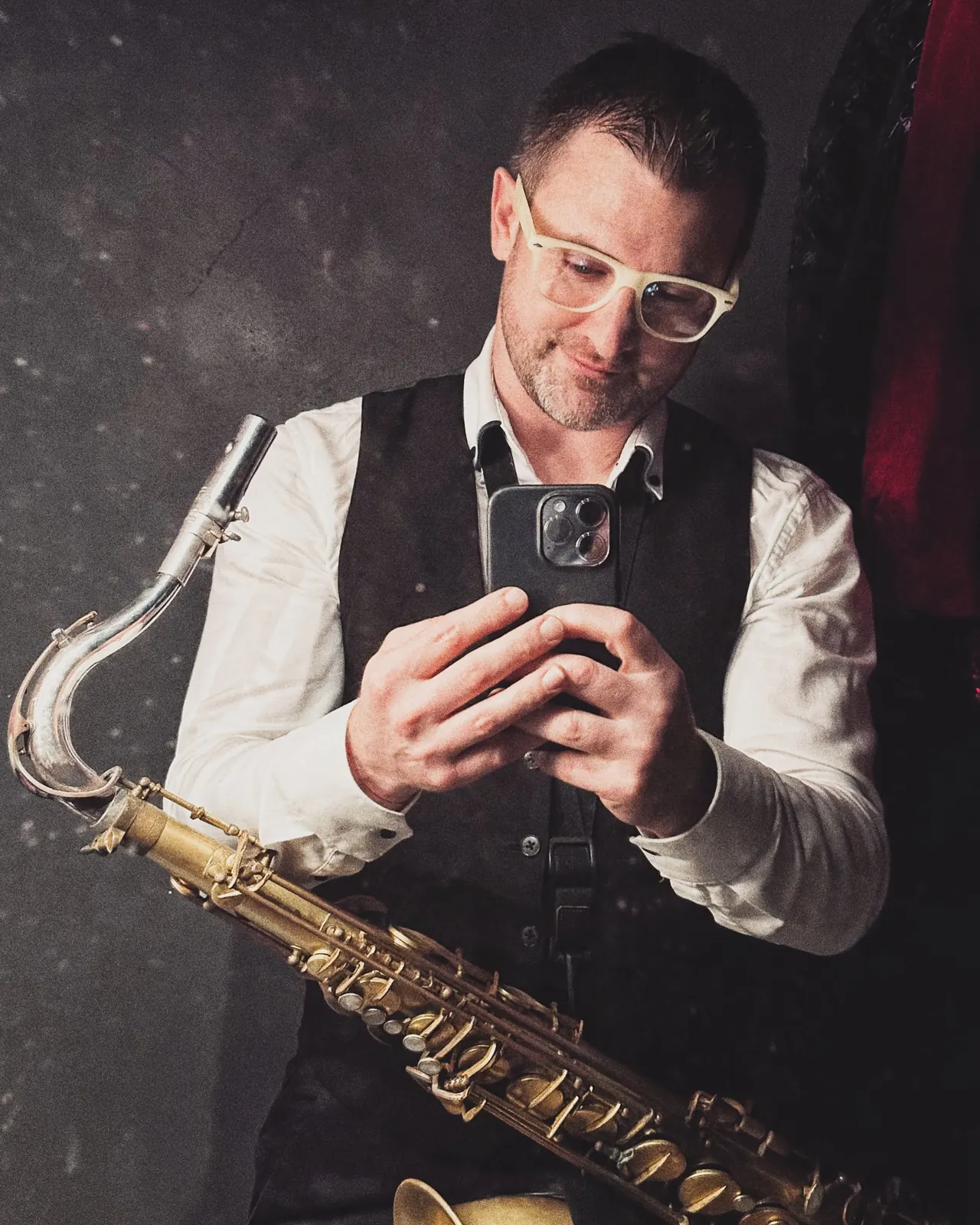 Portrait of George Kash holding his tenor saxophone